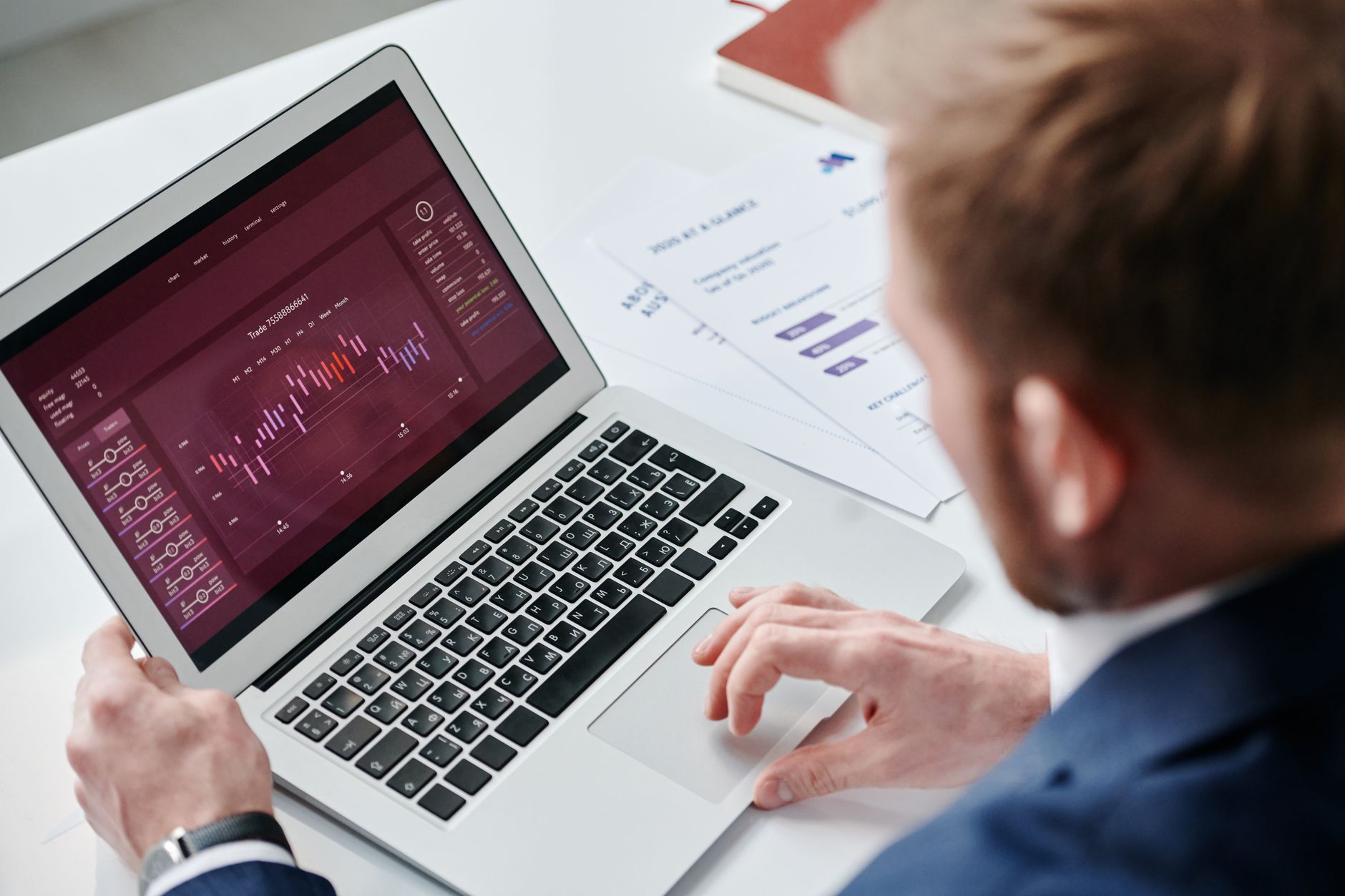 Small business owner working on a laptop with an automation dashboard in the office