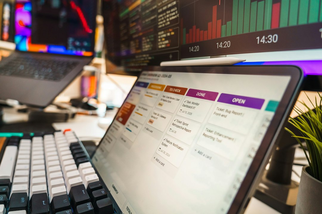 A tablet displaying a project management board with task cards on a desk